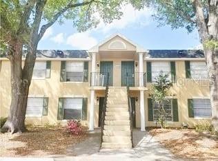 Front view of a two-story apartment building with a central staircase.