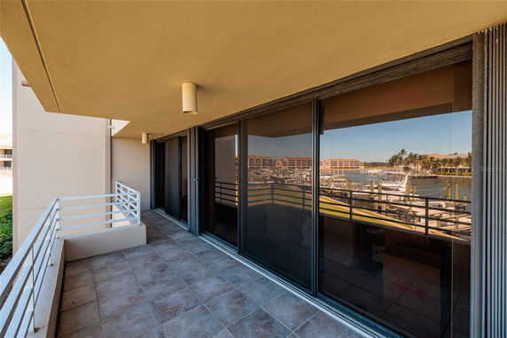 Balcony with a view of a marina and buildings across the water.