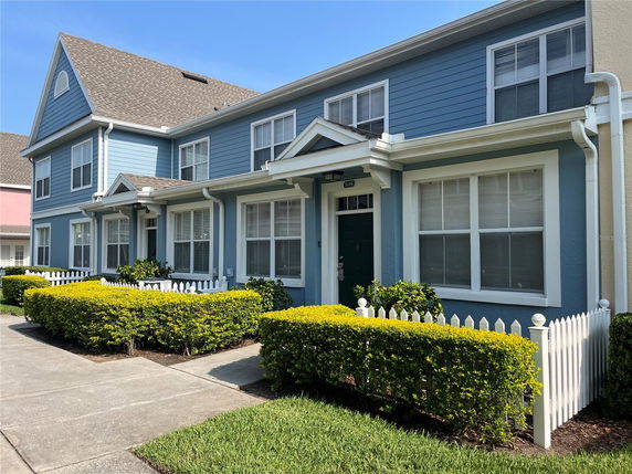 Front view of a two-story house with blue siding and white trim.