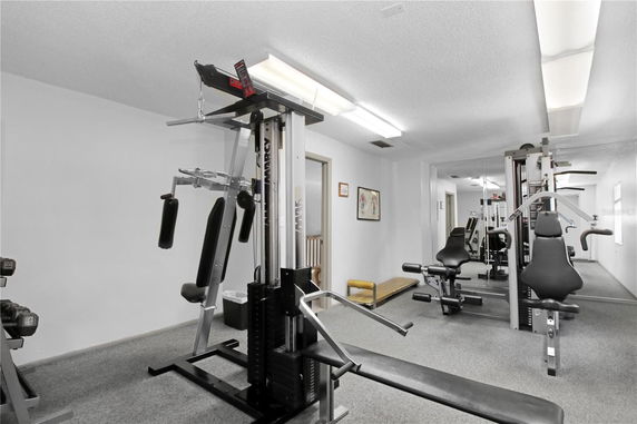 Indoor gym area with exercise equipment.