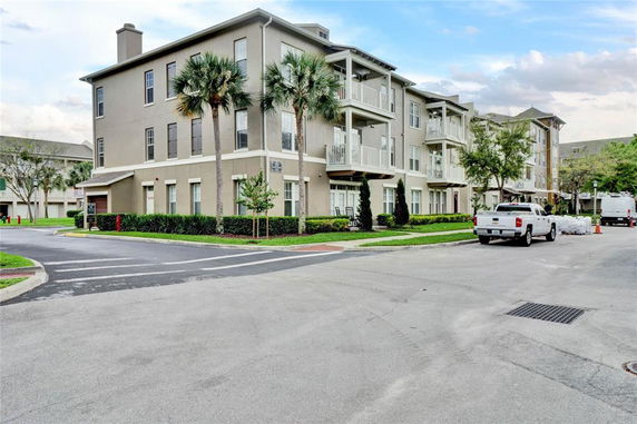 Front view of a multi-story residential building with multiple balconies.
