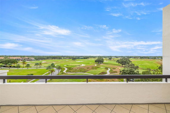 Panoramic view of a golf course seen from a building balcony.