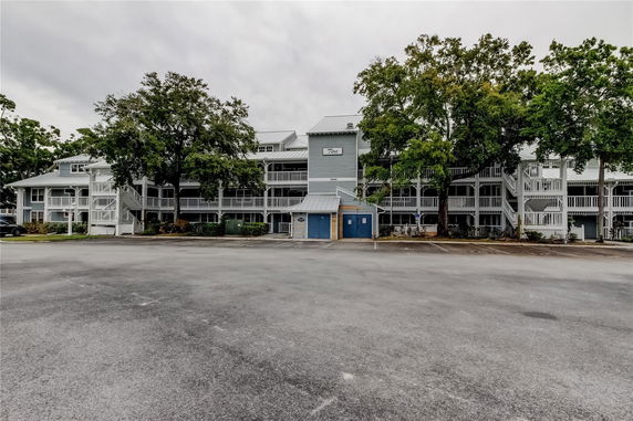Front view of a multi-story building with a parking area.