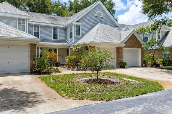 Front view of a two-story house with a garage and a driveway.