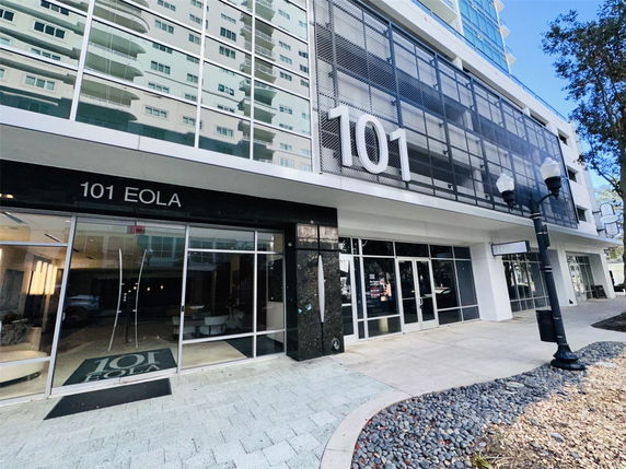 Front view of a building with a glass facade and the address number 101 displayed prominently.
