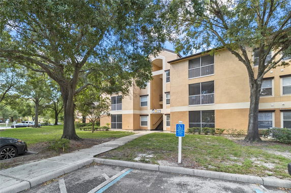 Front view of a multi-story apartment building with screened balconies.