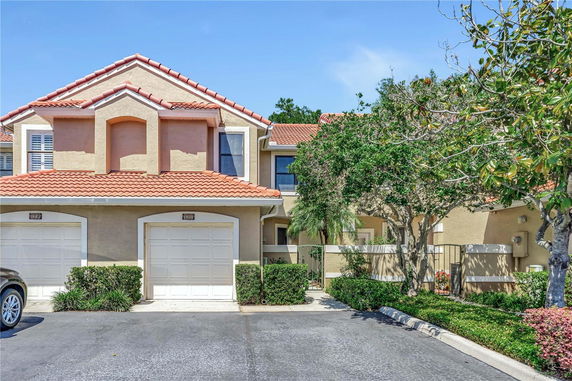 Front view of a two-story house with a double garage and red tiled roof.
