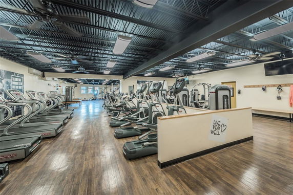 Interior view of a gym with treadmills and exercise machines.