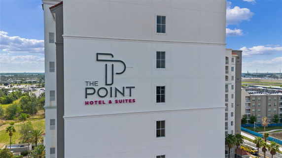Front view of a hotel building with signage.