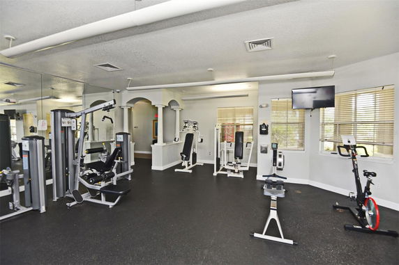 Interior view of a gym area with various exercise equipment.