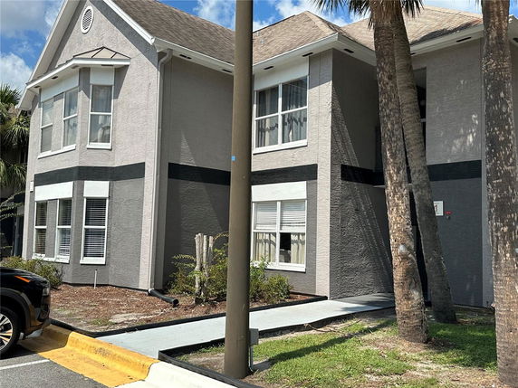 Front view of a two-story house with large windows and a gable roof.