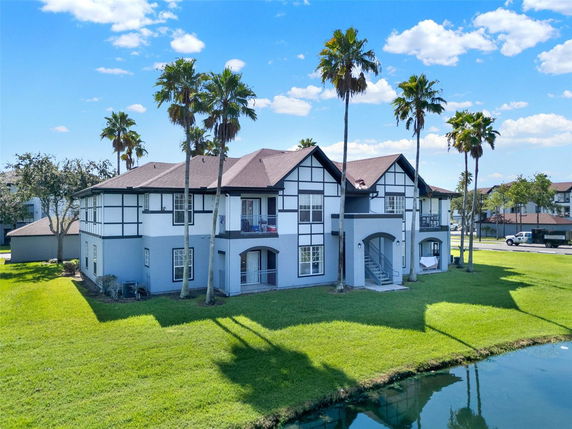 Front view of a two-story house with multiple gables and a landscaped lawn.