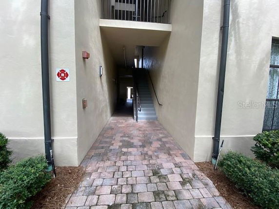 Entrance to a building with stairs leading to an upper floor.