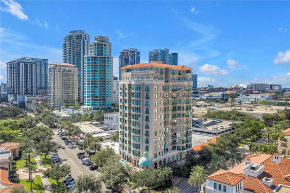 Front view of a modern multi-story building with distinctive architectural features and balconies.