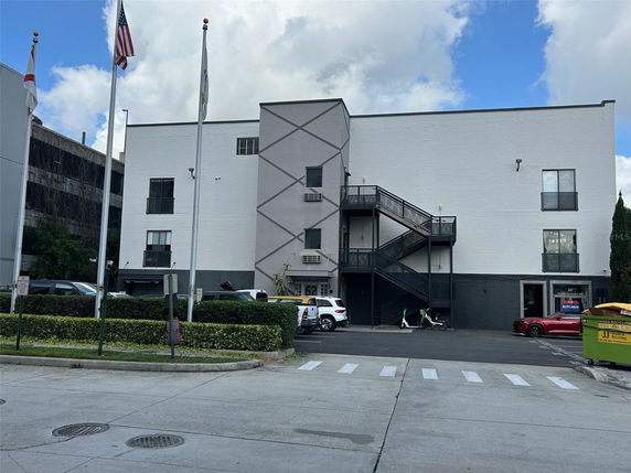 Front view of a three-story commercial building with external staircases.