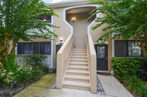Front view of a building with exterior stairs leading to the upper level.
