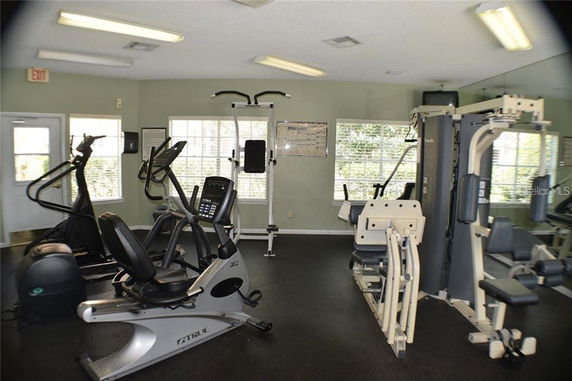 Interior view of a gym with exercise machines and equipment.