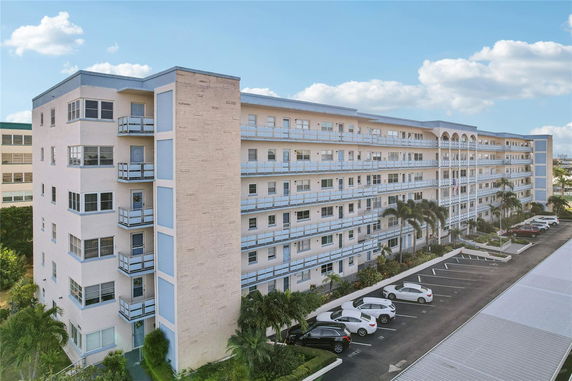 Front view of a multi-story residential building with balconies.