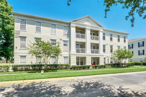 Front view of a three-story residential building with balconies.