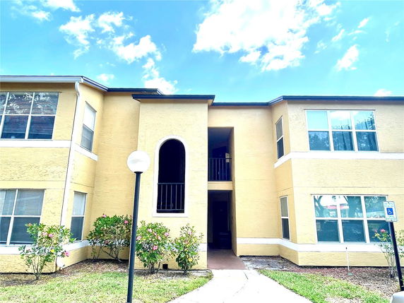 Front view of a two-story building with an arched entrance.