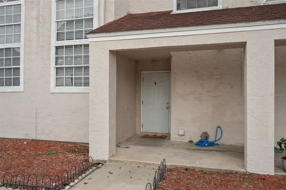 Front view of a house with a covered porch and door labeled B.