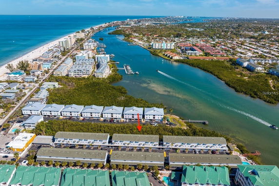 Aerial view of a coastal area with buildings and waterways stretching into the distance.