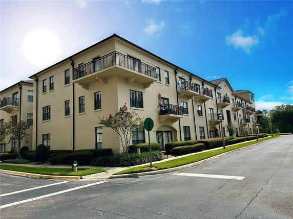 Front view of a multi-story apartment building with balconies.