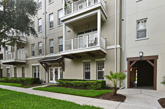 Front view of a multi-story apartment building with balconies.