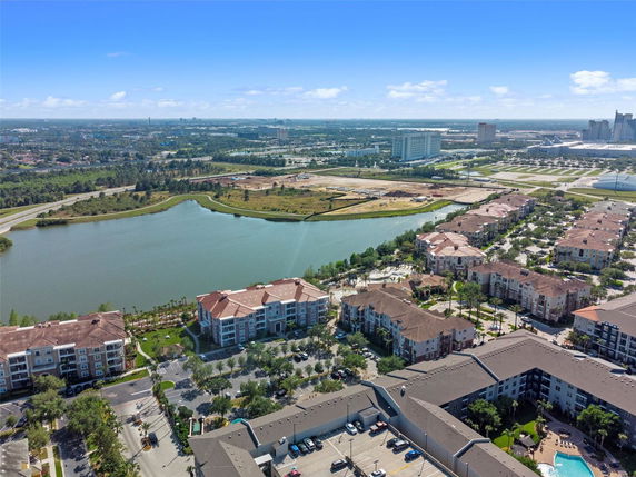 Panoramic view of apartment buildings surrounding a large body of water.
