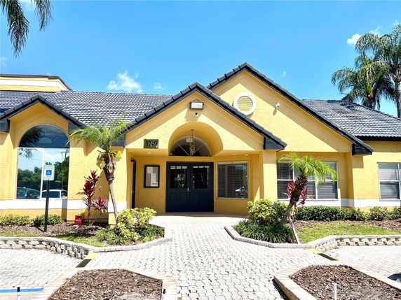 Front view of a house with a prominent entrance and arched windows.