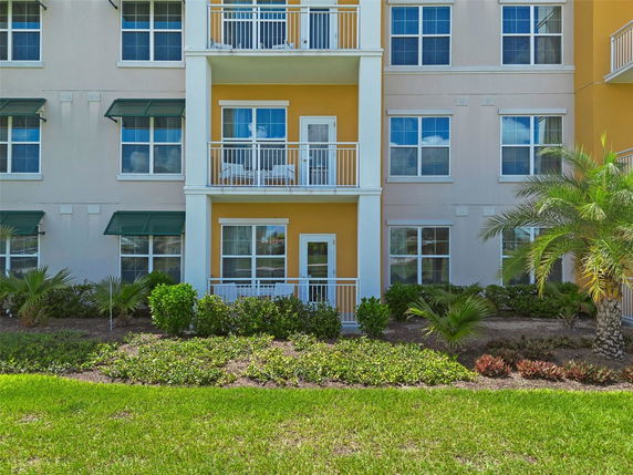 Front view of a multi-story residential building with balconies.