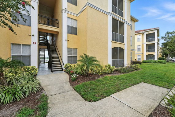 Front view of a multi-story apartment building with exterior stairs and balconies.