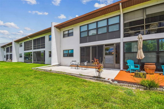 Back view of a two-story residential building with a patio.
