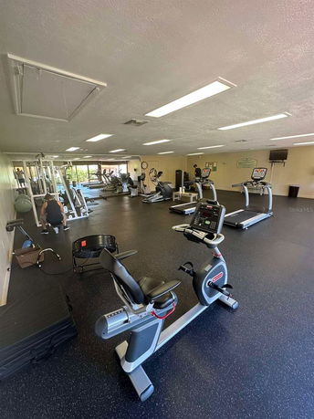 Indoor gym area with various exercise equipment.
