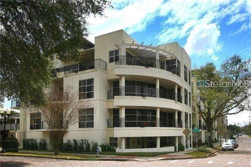 Front view of a modern multi-story building with balconies.