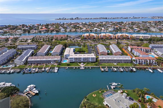 Aerial panoramic view of a coastal residential area with waterways and boats.