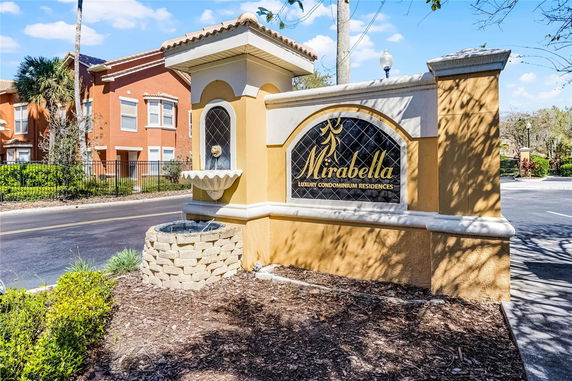 Entrance sign for Mirabella Luxury Condominium Residences with a decorative fountain.