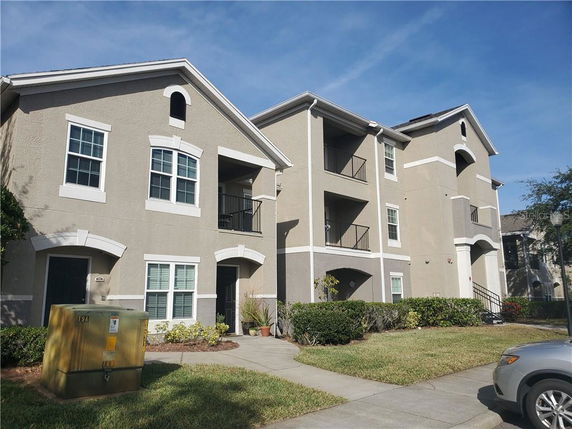 Front view of a multi-story apartment building with balconies.