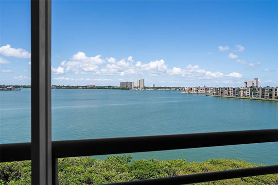 Panoramic view of a body of water with distant buildings on the shore.