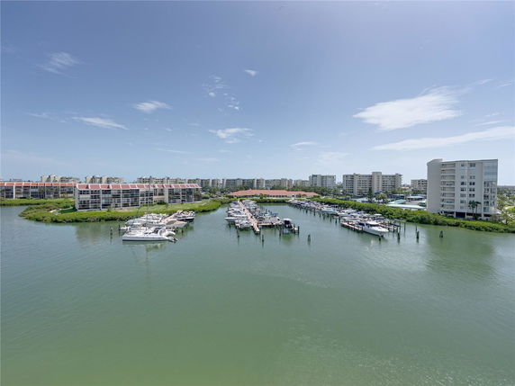 Wide angle view of waterfront buildings with boats docked.