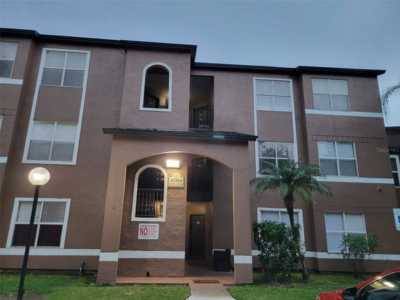 Front view of a multi-story apartment building with an entrance.