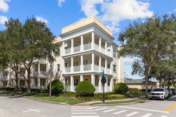 Front view of a three-story building with multiple balconies.