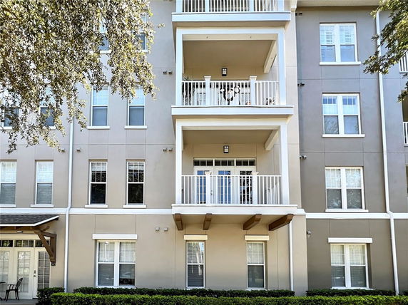 Front view of a multi-story residential building with balconies.