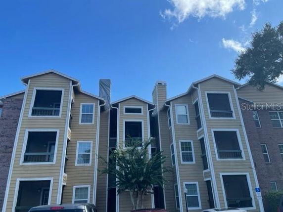Front view of a three-story apartment building with balconies.