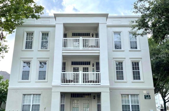 Front view of a multi-story building with balconies.