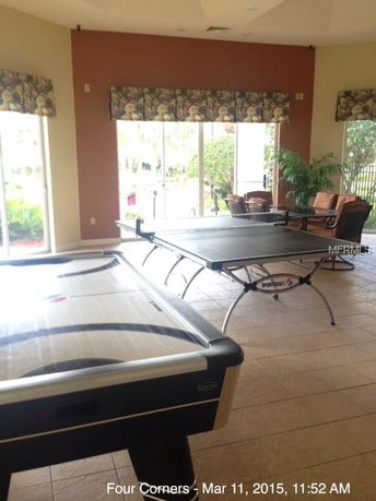 Indoor recreational area with table tennis and air hockey tables.