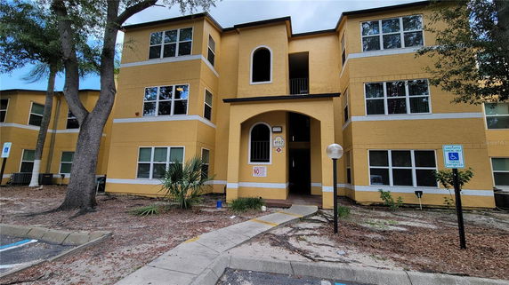 Front view of a two-story building with a central archway entrance.