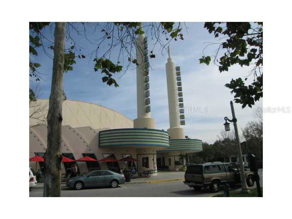 Front view of a building with distinct tall pillars and a dome-like structure.