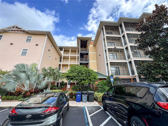 Front view of a multi-story apartment building with balconies.
