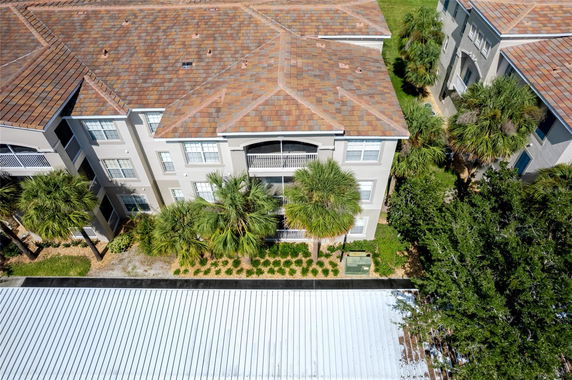 Front view of a multi-story apartment building with a tiled roof.